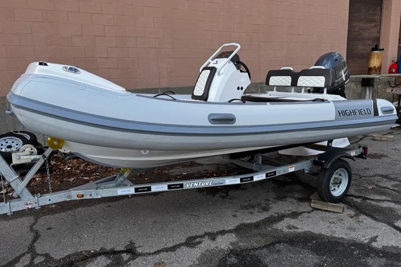 Slide: The Image of 2025 Highfield Sport 420 boat on trailer, parked outdoors. - 4