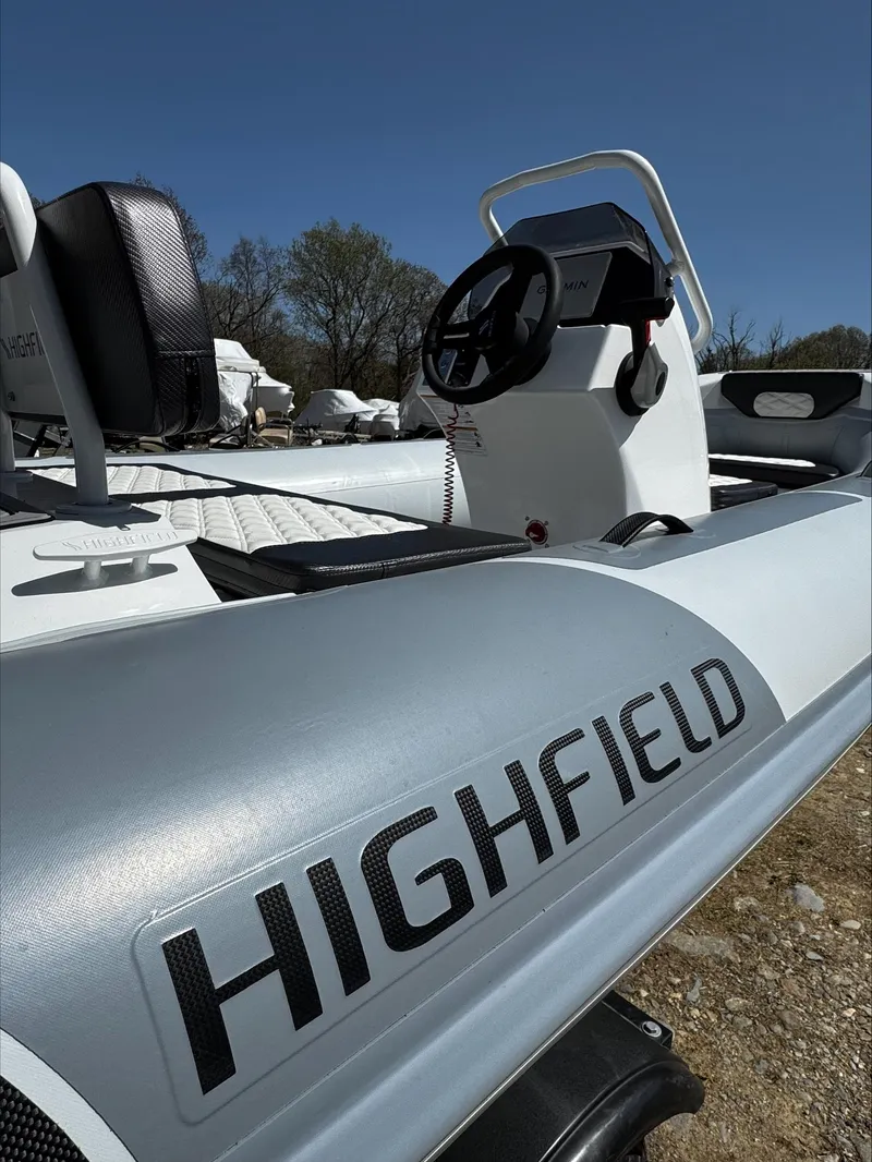 Slide: The Image of 2025 Highfield Sport 420 boat with steering console, outdoors under clear blue sky. - 7