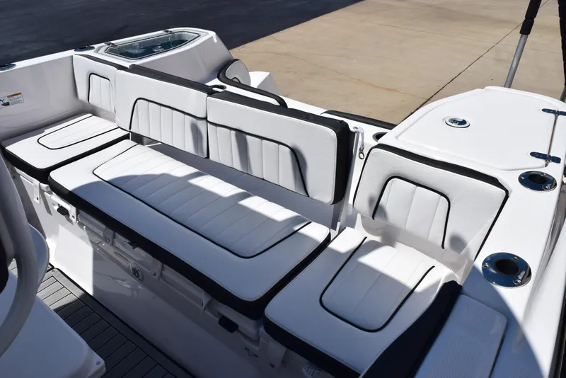 Slide: The Image of 2025 Yamaha Boats 255 FSH Sport E interior seating, white upholstery with black accents. - 10