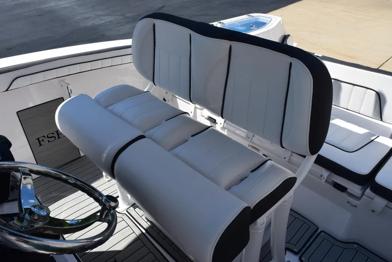 Slide: The Image of 2025 Yamaha Boats 255 FSH Sport E interior seating and steering wheel. - 11