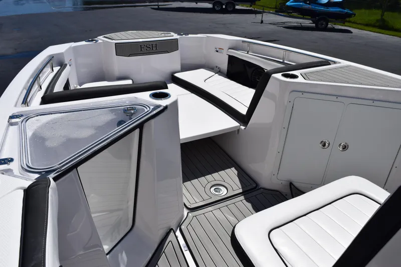 Slide: The Image of 2025 Yamaha Boats 255 FSH Sport E interior with seating and storage compartments. - 12