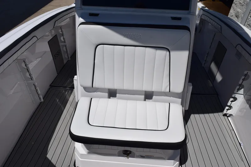 Slide: The Image of 2025 Yamaha Boats 255 FSH Sport E interior seating, featuring sleek white upholstery. - 13