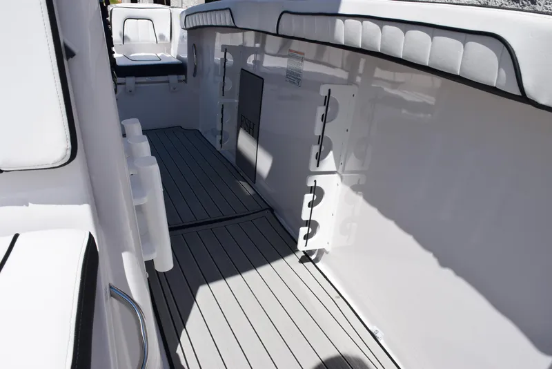 Slide: The Image of 2025 Yamaha Boats 255 FSH Sport E interior with sleek seating and storage compartments. - 14