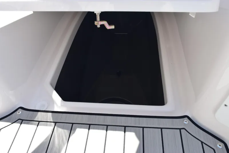 Slide: The Image of 2025 Yamaha Boats 255 FSH Sport E storage compartment with sleek flooring. - 16