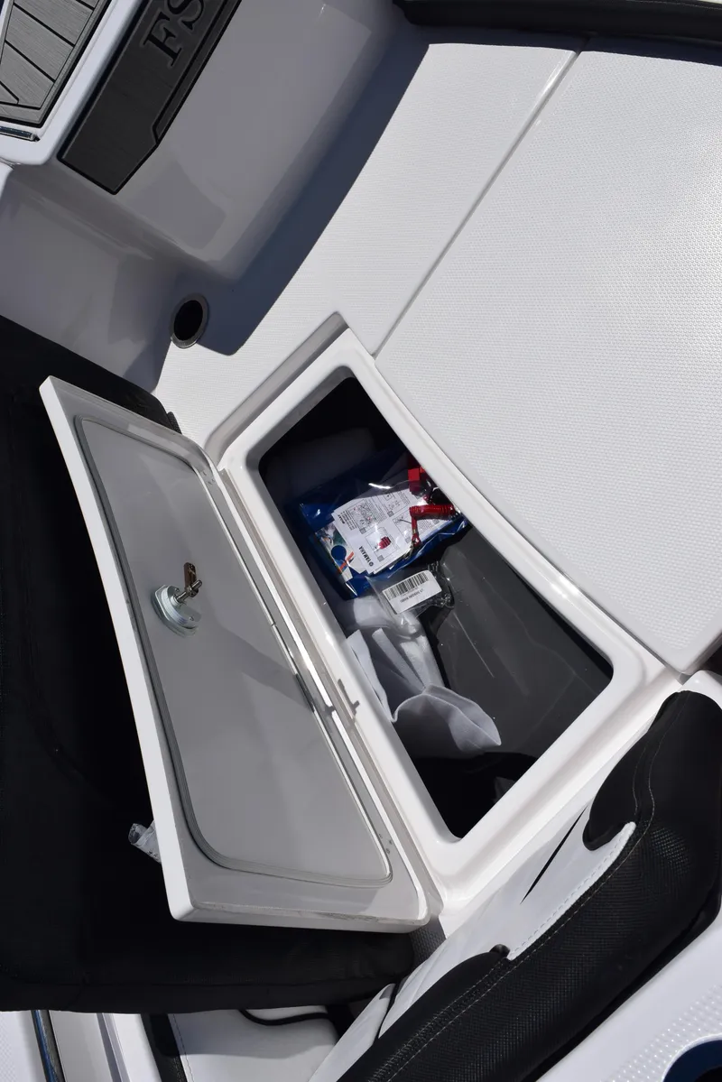 Slide: The Image of 2025 Yamaha Boats 255 FSH Sport E storage compartment with open hatch. - 20