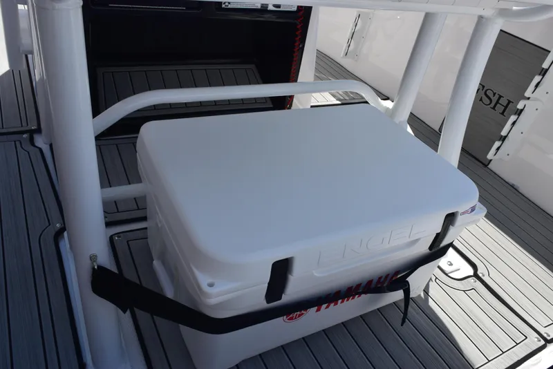 Slide: The Image of Yamaha Boats 2025 255 FSH Sport E with secured cooler on deck. - 22