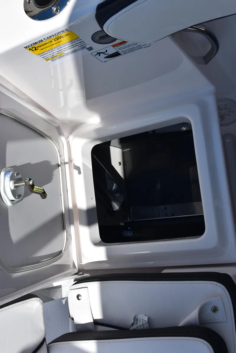 Slide: The Image of 2025 Yamaha Boats 255 FSH Sport E storage compartment interior. - 23