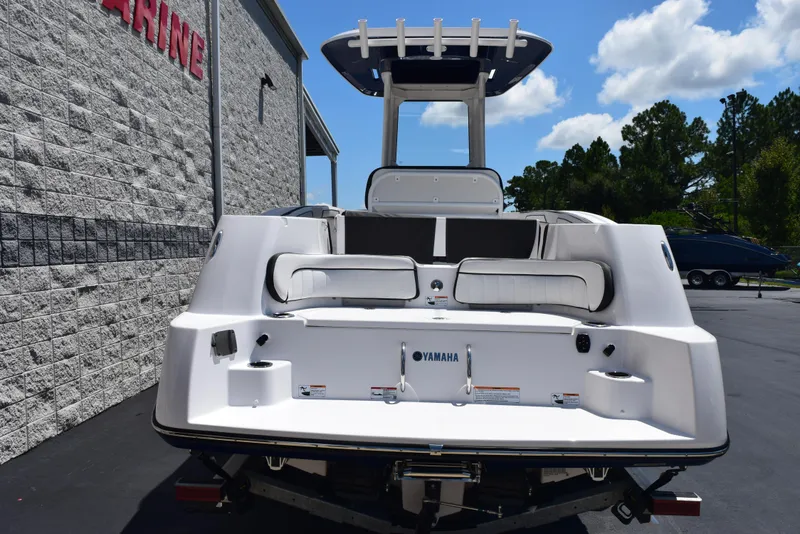 Slide: The Image of 2025 Yamaha Boats 255 FSH Sport E, rear view, parked outdoors. - 4