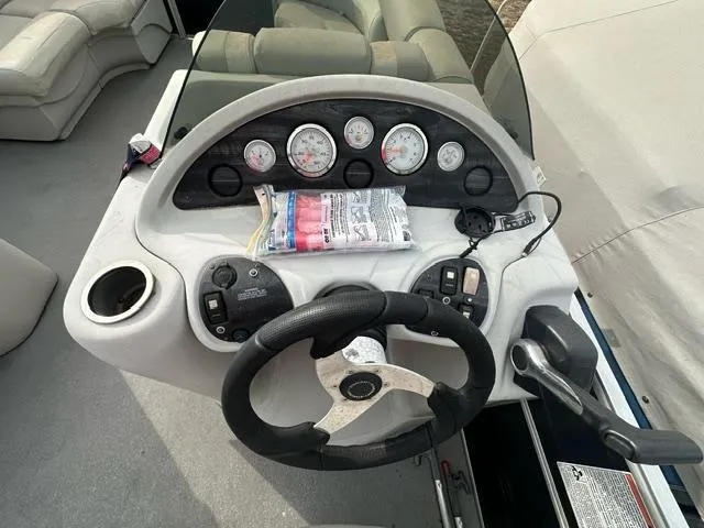 Slide: The Image of 2015 Starcraft Stardeck 206 Cruise-N-Fish boat dashboard with steering wheel and gauges. - 4