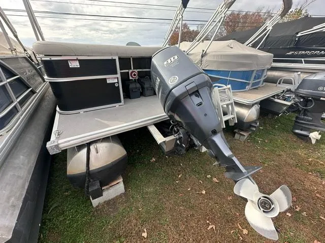 Slide: The Image of 2015 Starcraft Stardeck 206 Cruise-N-Fish pontoon boat with outboard motor, docked on grass. - 6