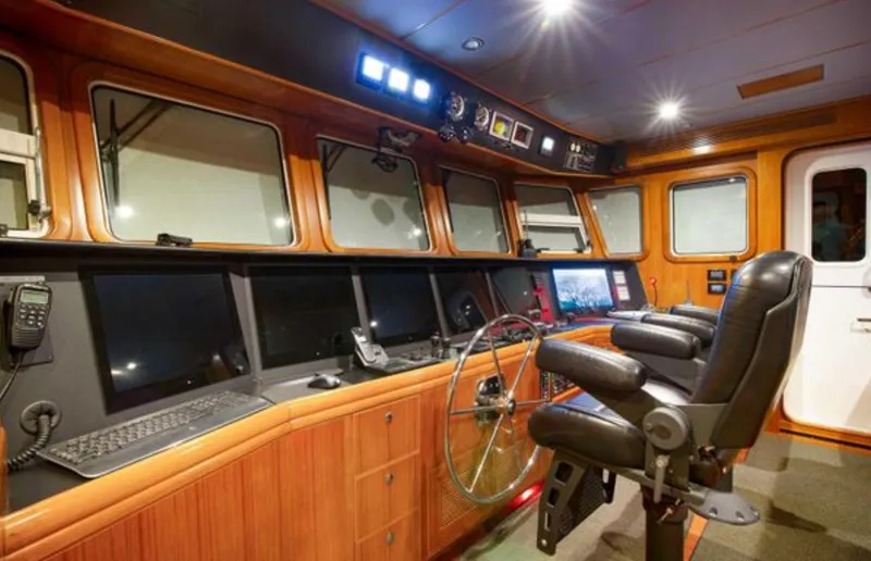 Slide: The Image of Luxurious 2009 Nordhavn 76 yacht helm with advanced navigation equipment and comfortable captain's chair. - 11
