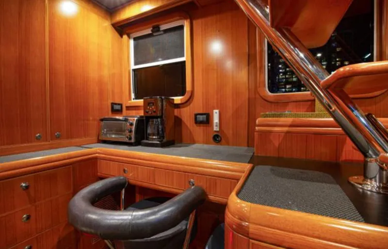 Slide: The Image of Luxurious 2009 Nordhavn 76 yacht interior with wood paneling and modern appliances. - 13
