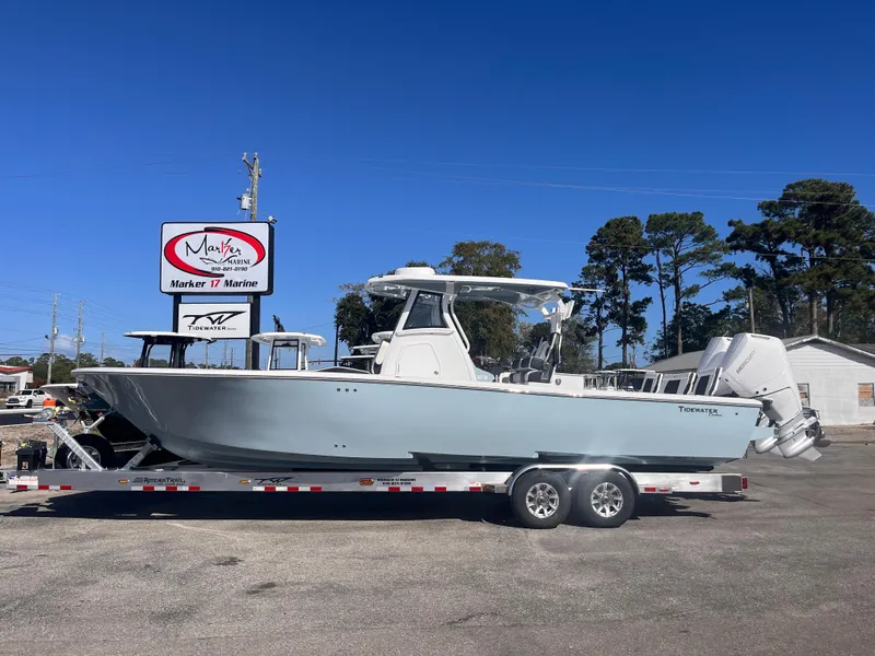 The Image of 2025 Tidewater 3100 Carolina Bay boat on trailer, parked outdoors under clear blue sky. - 1