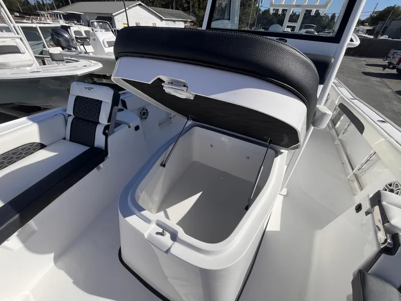 Slide: The Image of 2025 Tidewater 3100 Carolina Bay boat with open storage compartment and seating. - 14