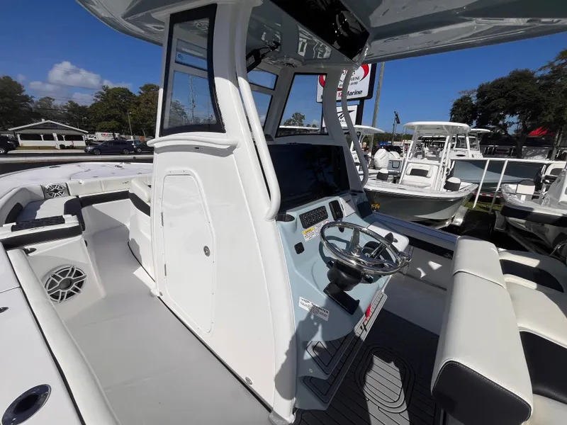 Slide: The Image of 2025 Tidewater 3100 Carolina Bay boat interior with modern helm and seating. - 16