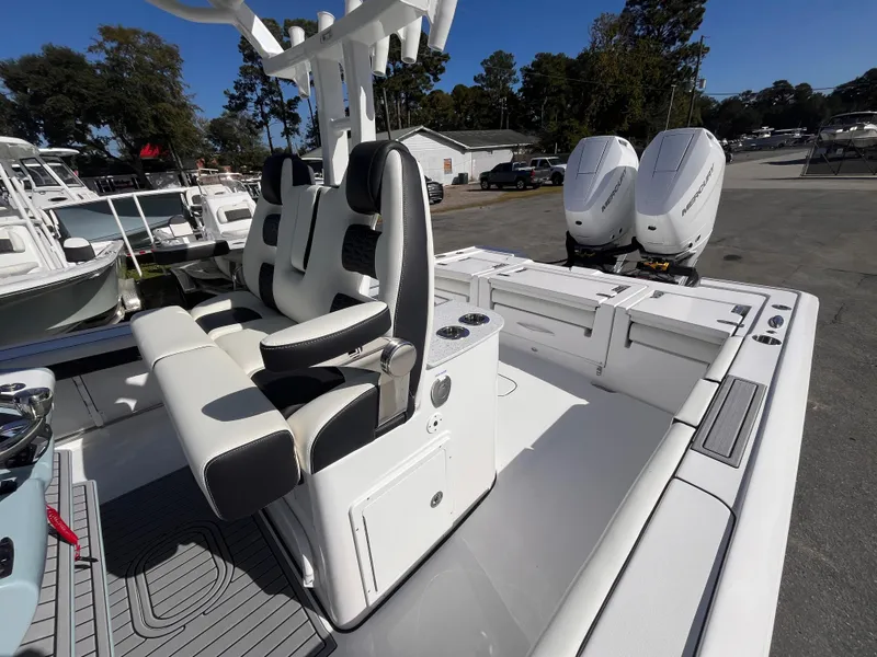 Slide: The Image of 2025 Tidewater 3100 Carolina Bay boat with dual engines and sleek seating. - 19