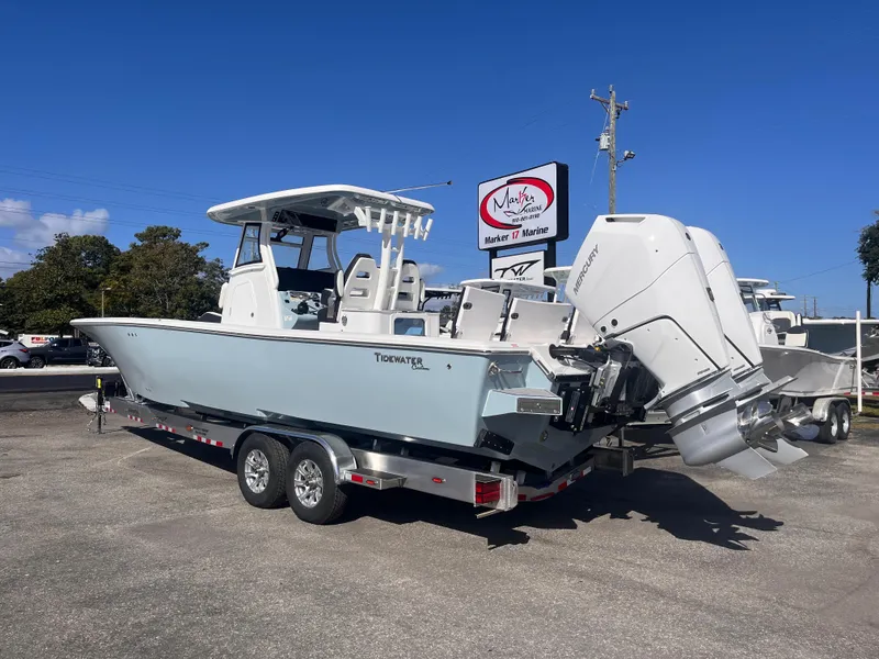 Slide: The Image of 2025 Tidewater 3100 Carolina Bay boat on trailer, parked outdoors. - 3