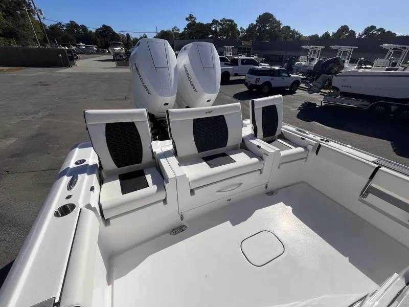 Slide: The Image of 2025 Tidewater 3100 Carolina Bay boat with dual engines and seating in a marina. - 6