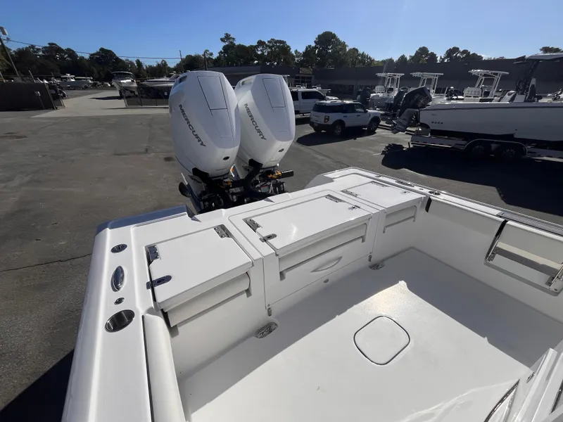 Slide: The Image of 2025 Tidewater 3100 Carolina Bay boat with dual outboard engines in a marina. - 7