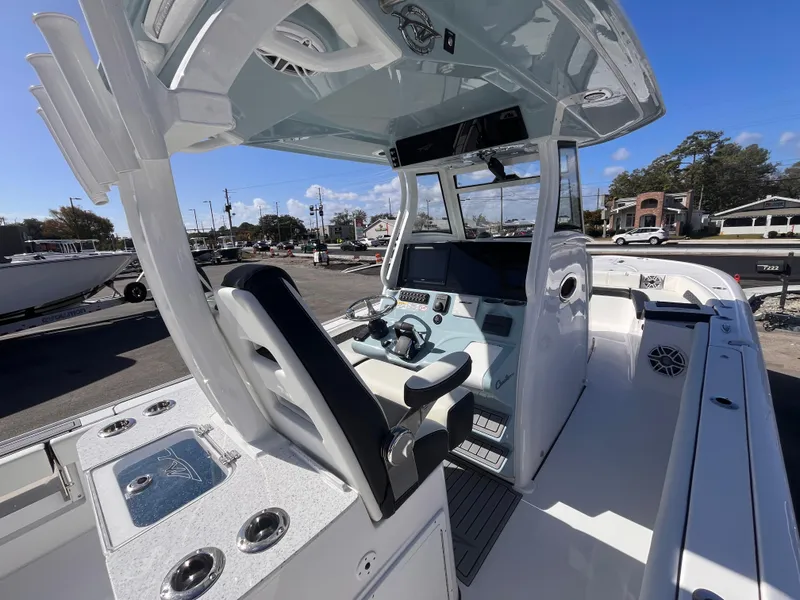Slide: The Image of 2025 Tidewater 3100 Carolina Bay boat interior with modern helm and seating. - 9