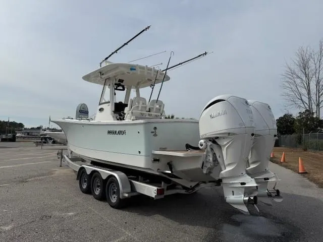 Slide: The Image of 2022 Regulator 28 boat on trailer with twin Yamaha engines. - 10