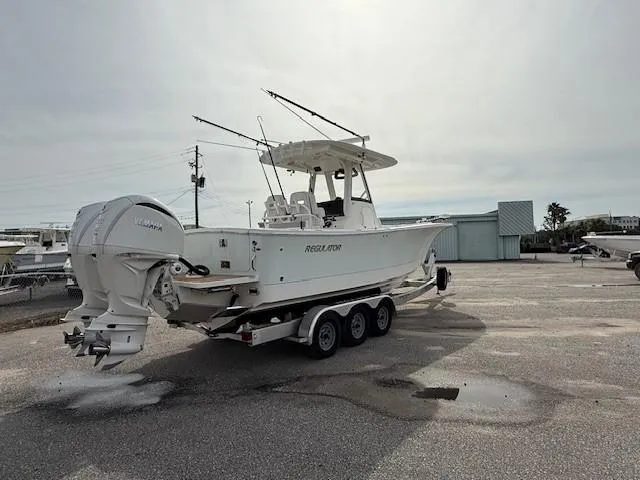 Slide: The Image of 2022 Regulator 28 boat on a trailer in a parking lot. - 6