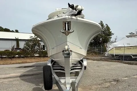Slide: The Image of 2022 Regulator 28 boat on trailer, front view, parked outdoors. - 8