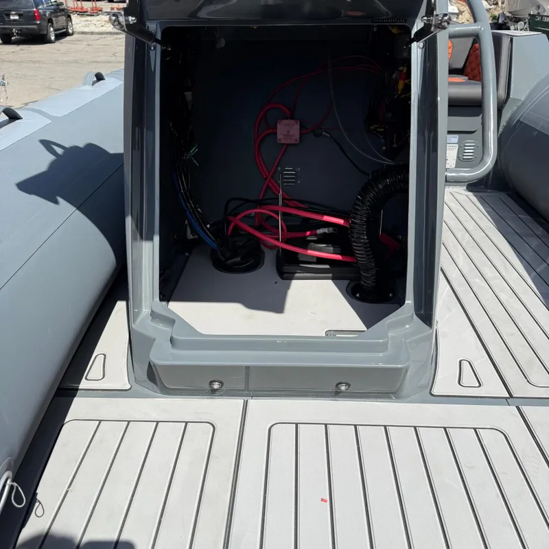 Slide: The Image of 2025 Highfield Sport 520 boat interior with open storage compartment and visible wiring. - 5