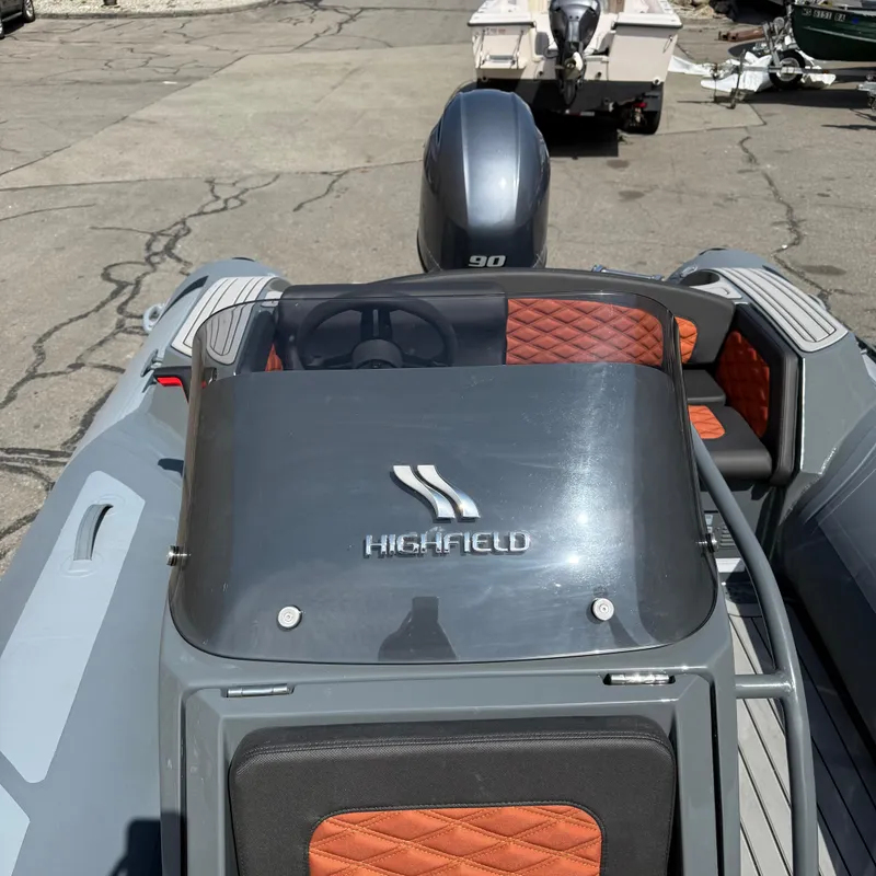 Slide: The Image of 2025 Highfield Sport 520 boat with sleek design and orange quilted seats. - 7