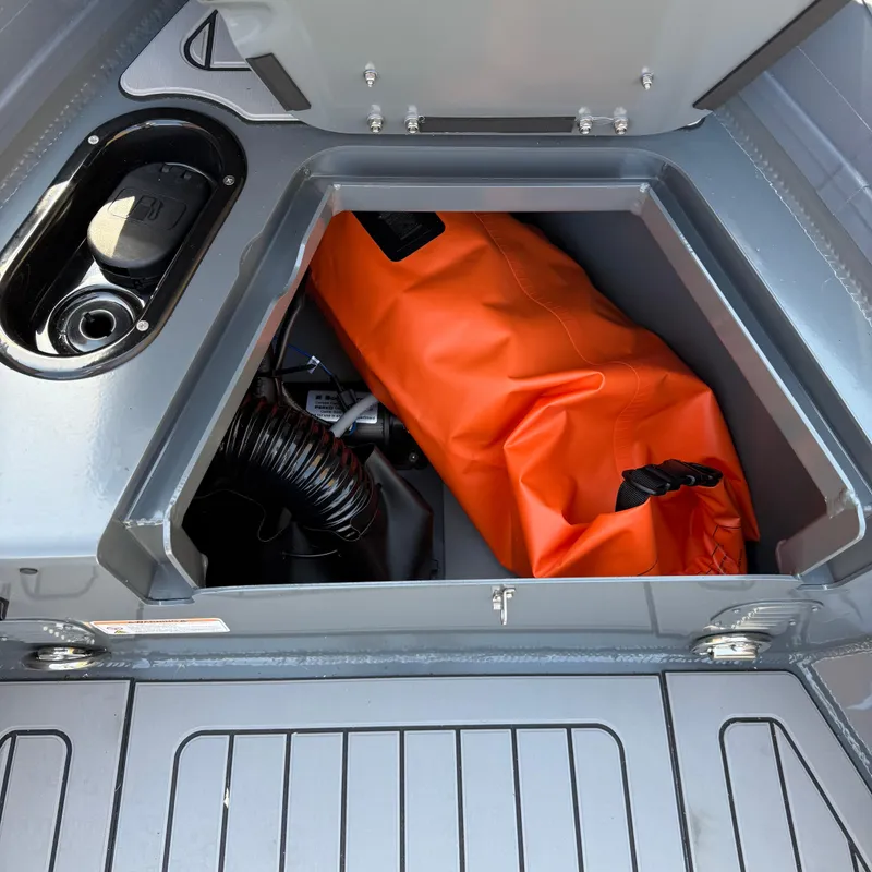 Slide: The Image of Storage compartment of 2025 Highfield Sport 520 boat with orange bag inside. - 8