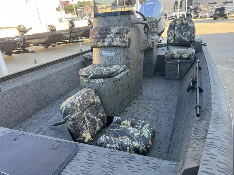 Slide: The Image of 2025 War Eagle 961 Blackhawk boat with camouflage seating and fishing rod holder. - 10