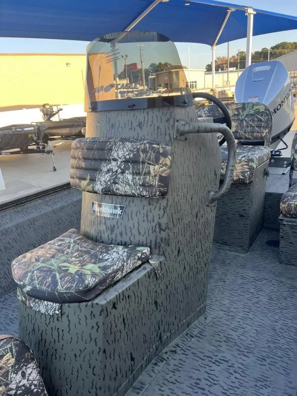 Slide: The Image of 2025 War Eagle 961 Blackhawk boat with camouflage seating and steering console. - 11