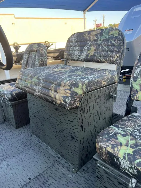Slide: The Image of 2025 War Eagle 961 Blackhawk boat with camo seating and storage. - 13