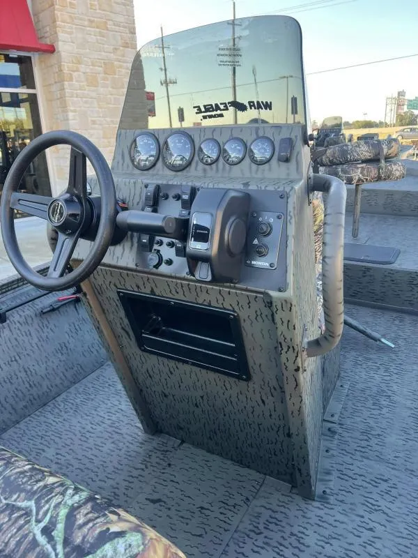 Slide: The Image of 2025 War Eagle 961 Blackhawk boat console with steering wheel and gauges. - 17
