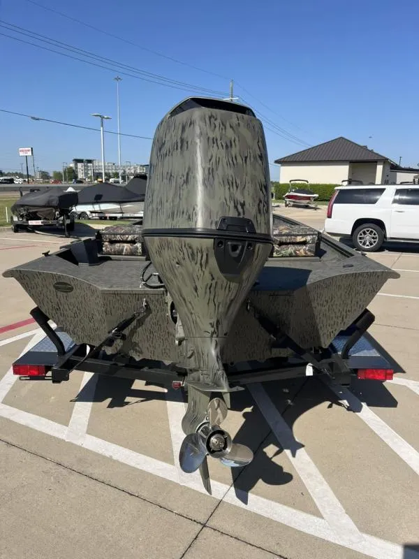 Slide: The Image of 2025 War Eagle 961 Blackhawk boat with camouflage design on a trailer. - 4