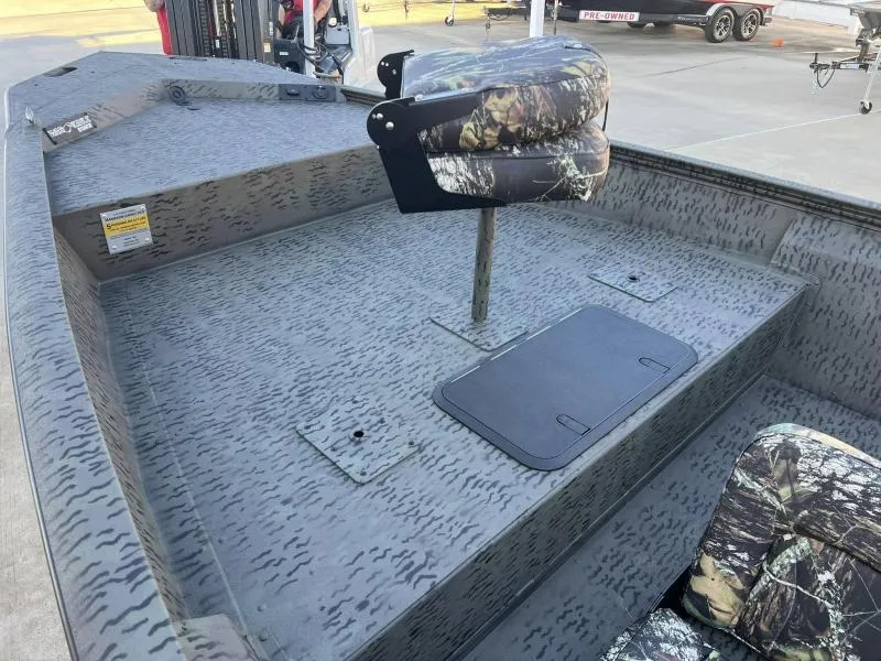 Slide: The Image of 2025 War Eagle 961 Blackhawk boat interior with camo seats and textured flooring. - 9
