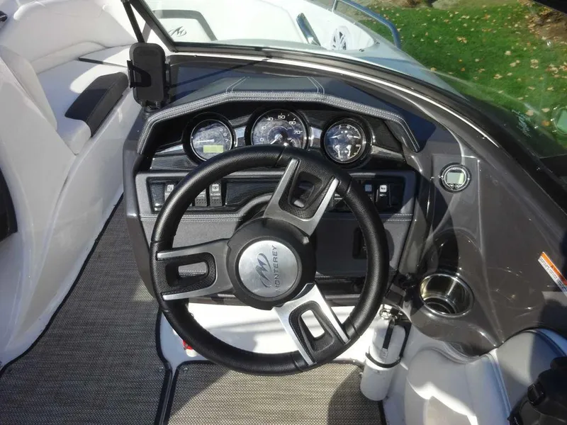 Slide: The Image of 2021 Monterey 224FS boat dashboard with steering wheel and gauges. - 13