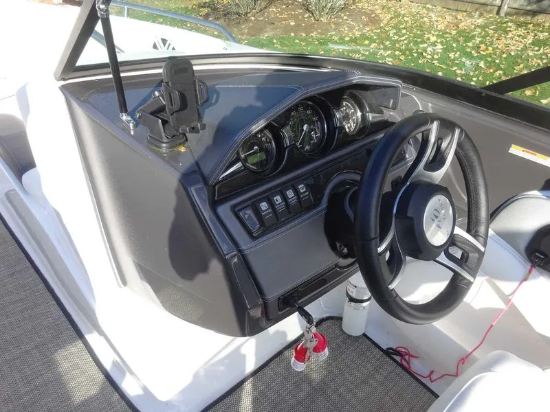Slide: The Image of 2021 Monterey 224FS boat dashboard with steering wheel and control panel. - 14