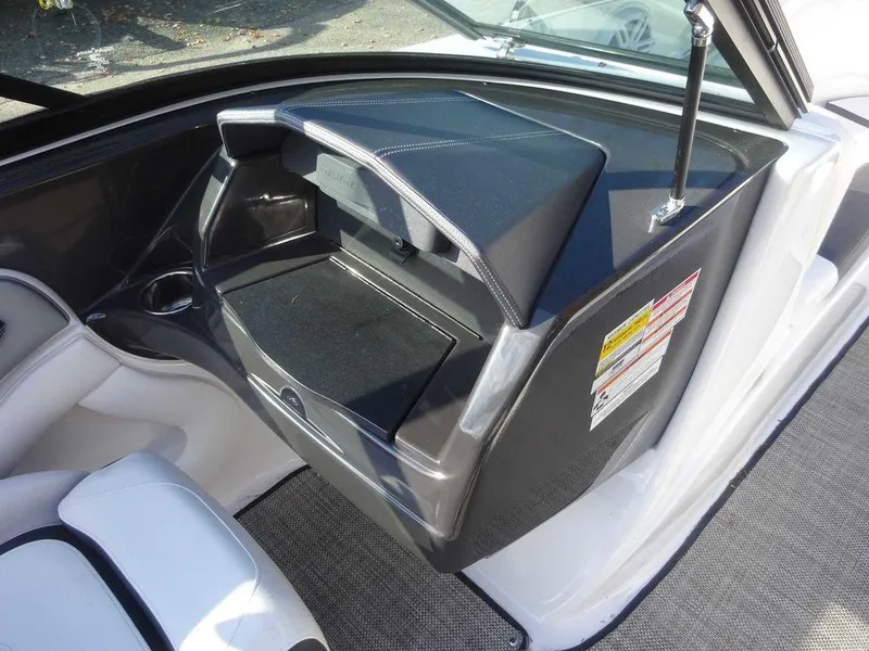 Slide: The Image of 2021 Monterey 224FS boat interior storage compartment with sleek design and safety labels. - 16