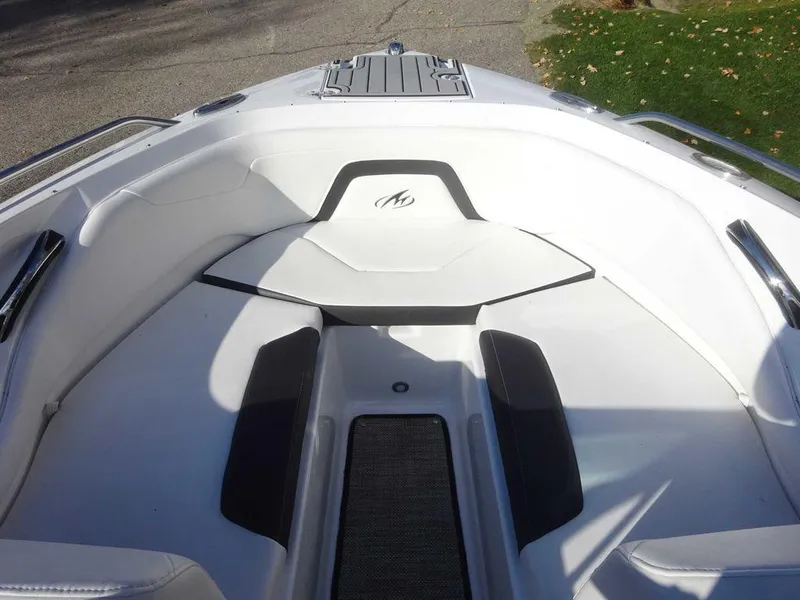 Slide: The Image of 2021 Monterey 224FS boat interior with sleek white and black seating. - 17