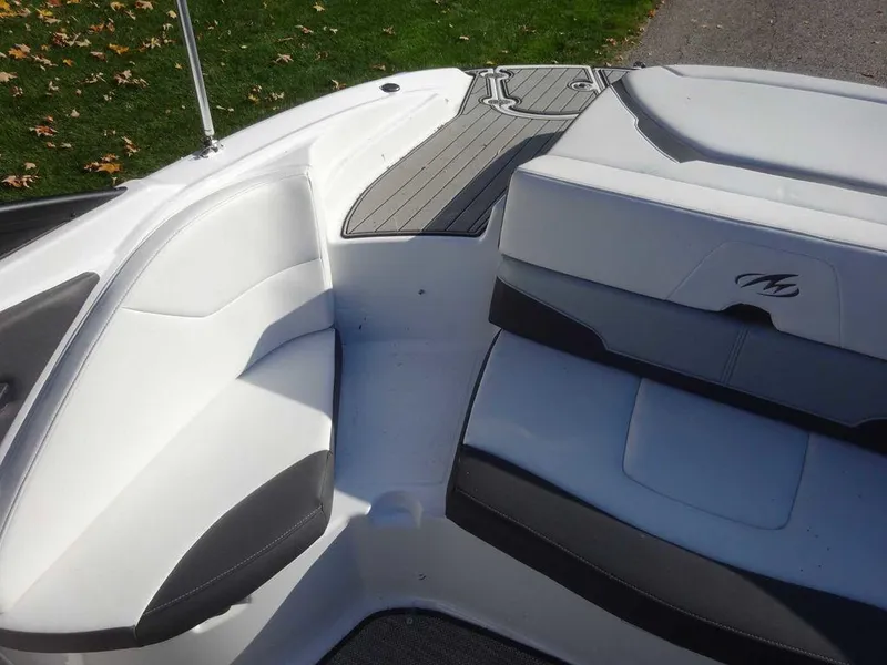 Slide: The Image of 2021 Monterey 224FS boat interior with white and gray seating. - 19