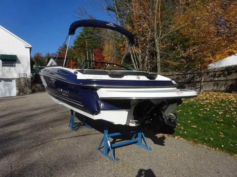 Slide: The Image of 2021 Monterey 224FS boat on stands, parked outdoors in a driveway. - 5