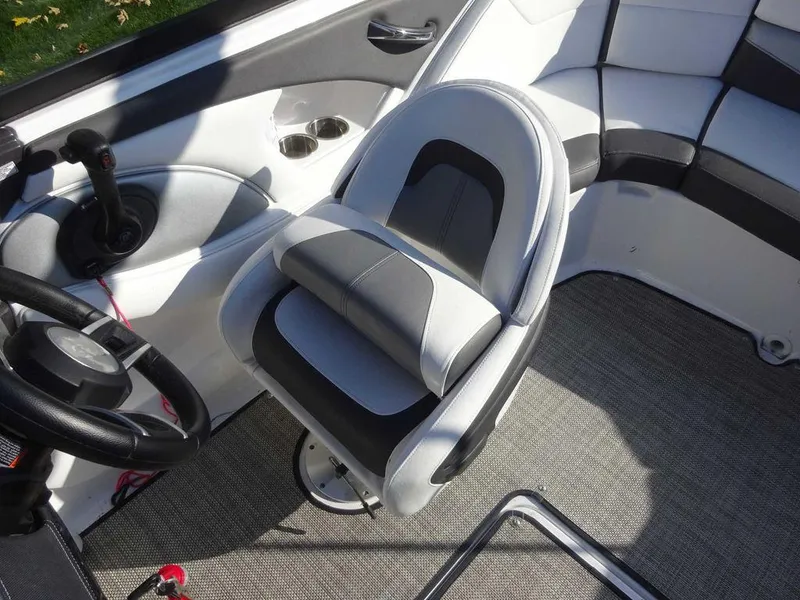 Slide: The Image of 2021 Monterey 224FS boat interior with gray seating and steering wheel. - 9