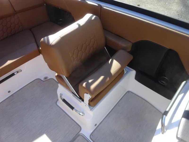 Slide: The Image of 2023 Four Winns H2 Sterndrive boat interior with brown seating and modern design. - 10
