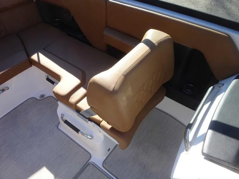 Slide: The Image of 2023 Four Winns H2 Sterndrive boat interior with tan seating and modern design. - 12