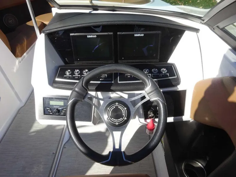 Slide: The Image of 2023 Four Winns H2 Sterndrive dashboard with dual Simrad displays and modern steering wheel. - 14
