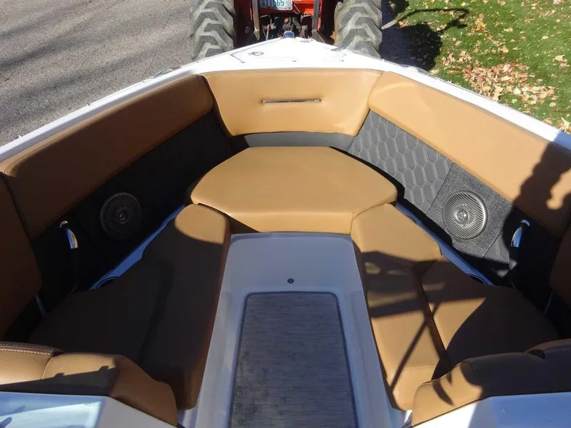 Slide: The Image of 2023 Four Winns H2 Sterndrive boat interior with tan seating and speakers. - 17