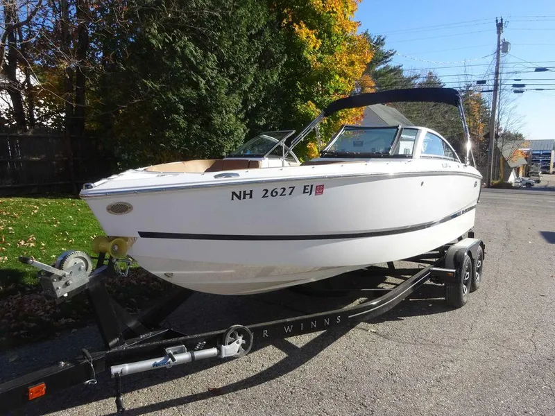 Slide: The Image of 2023 Four Winns H2 Sterndrive boat on trailer, parked on street. - 3