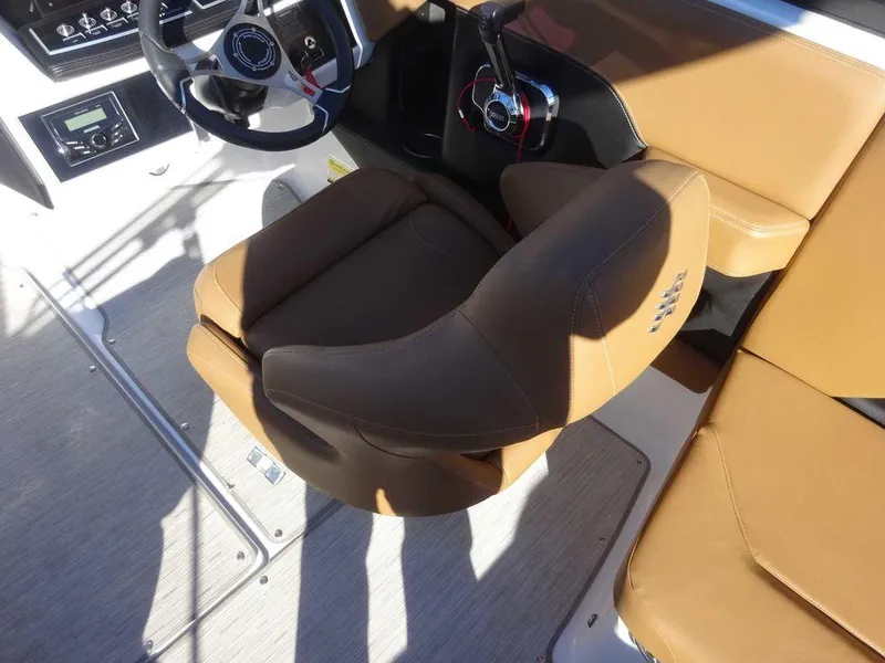Slide: The Image of 2023 Four Winns H2 Sterndrive boat interior with tan seating and steering console. - 5