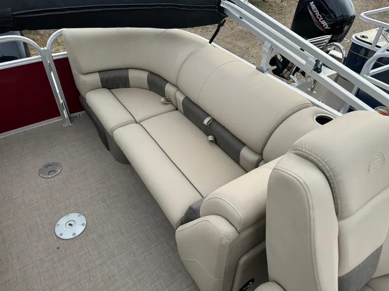 Slide: The Image of 2022 Sun Tracker Party Barge 22 XP3 interior with beige seating and carpeted floor. - 13